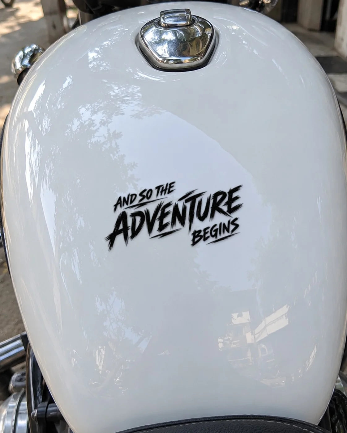 Adventure Begins bike patch in black ink on a bike