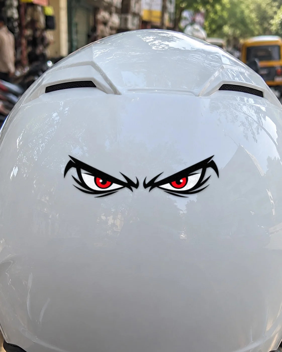 Angry Eyes bike patch in black ink on a helmet