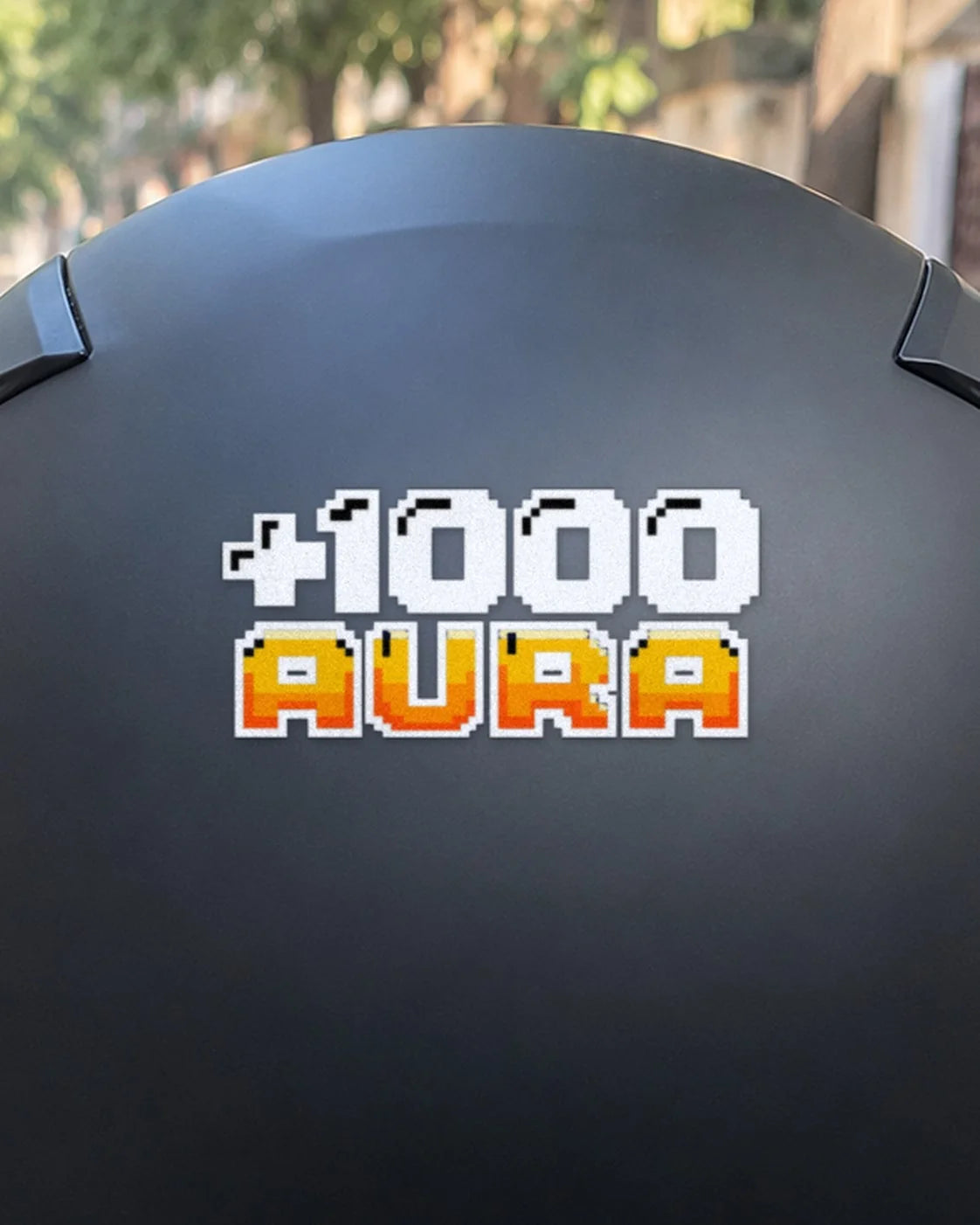 +1000 Aura bike patch in white ink on a helmet