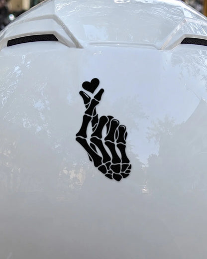Bone Heart bike patch in black ink on a helmet