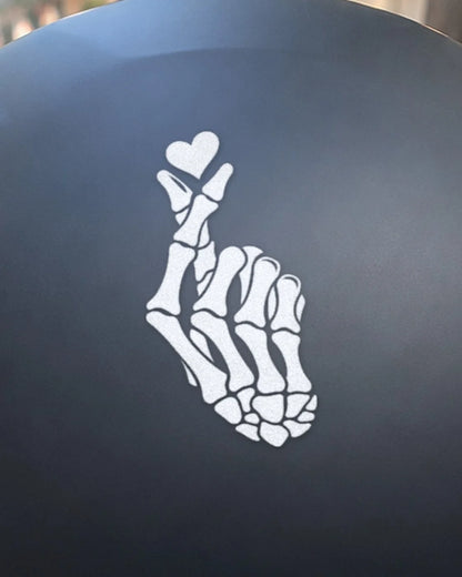 Bone Heart bike patch in white ink on a helmet