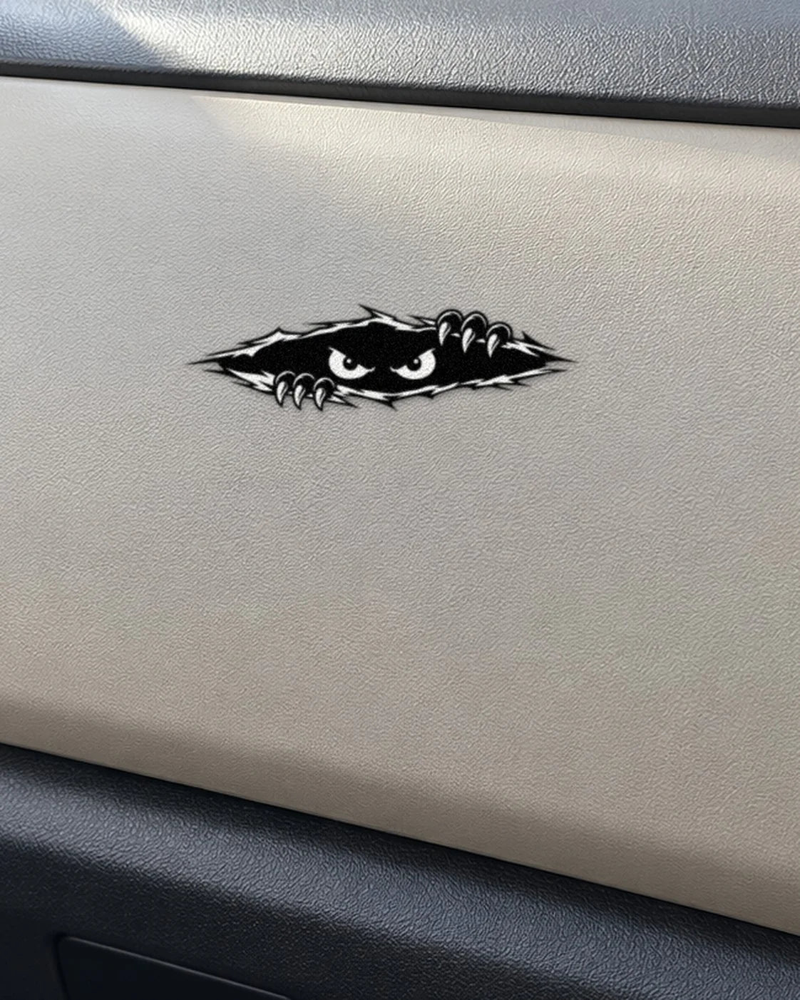 Peeking Eyes car patch in black on a car