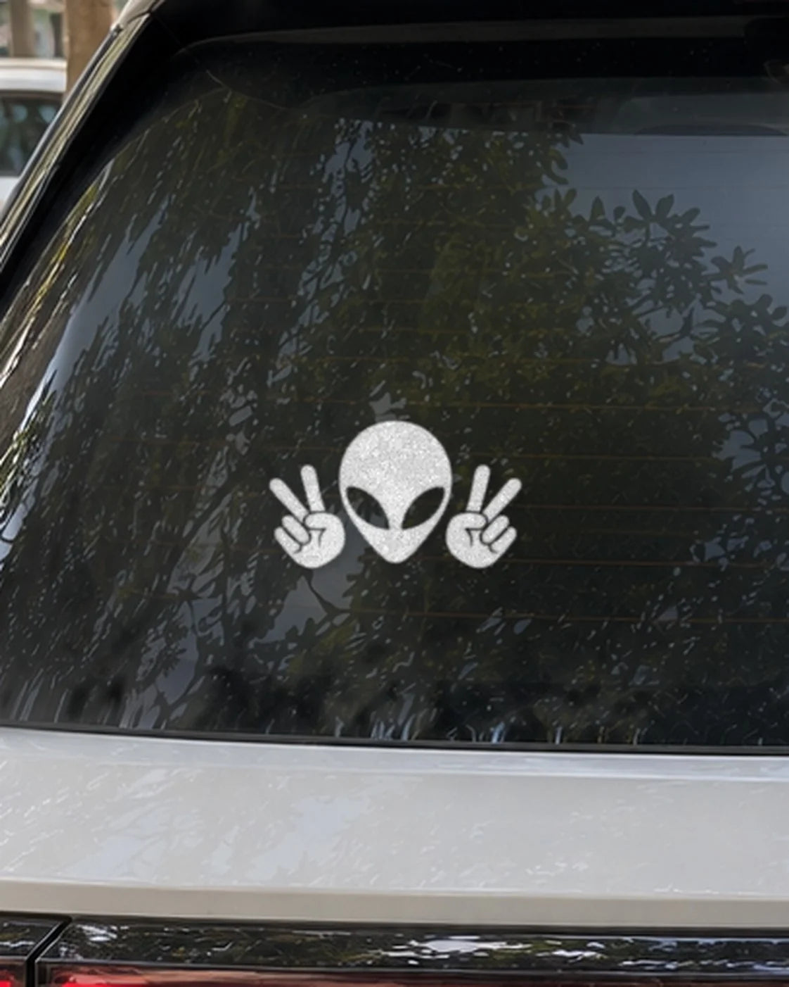 Peace Alien car patch in white on a car