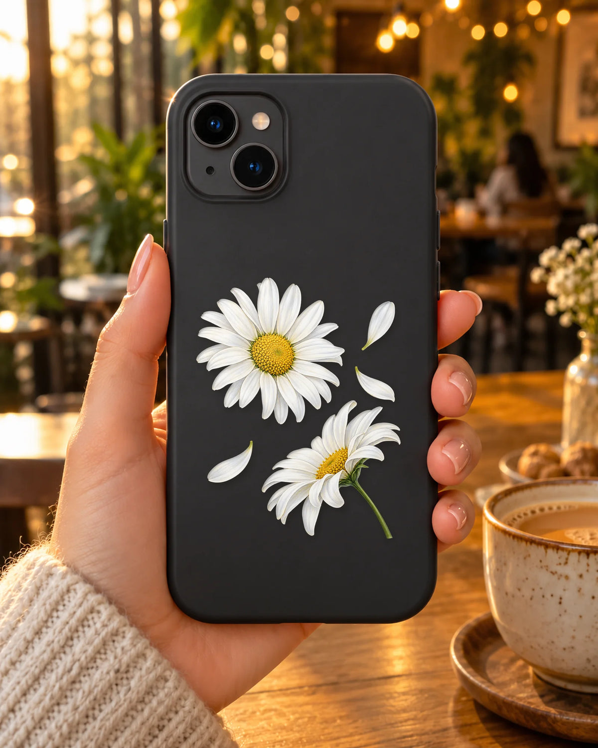 Daisy Duo on a phone at a cafe