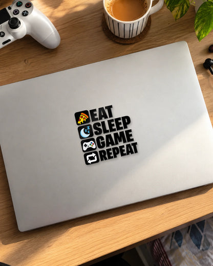Eat Sleep Game Repeat gamer patch in black ink on a laptop