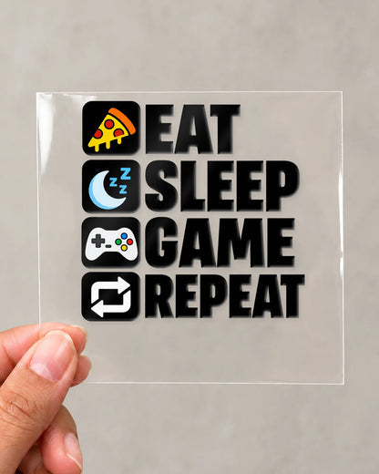 Eat Sleep Game Repeat gamer patch in black ink on clear film