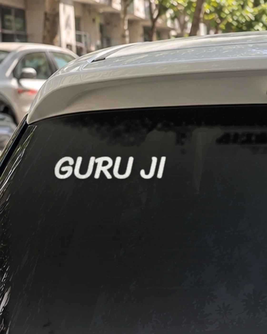 Guruji car patch on a car rear glass