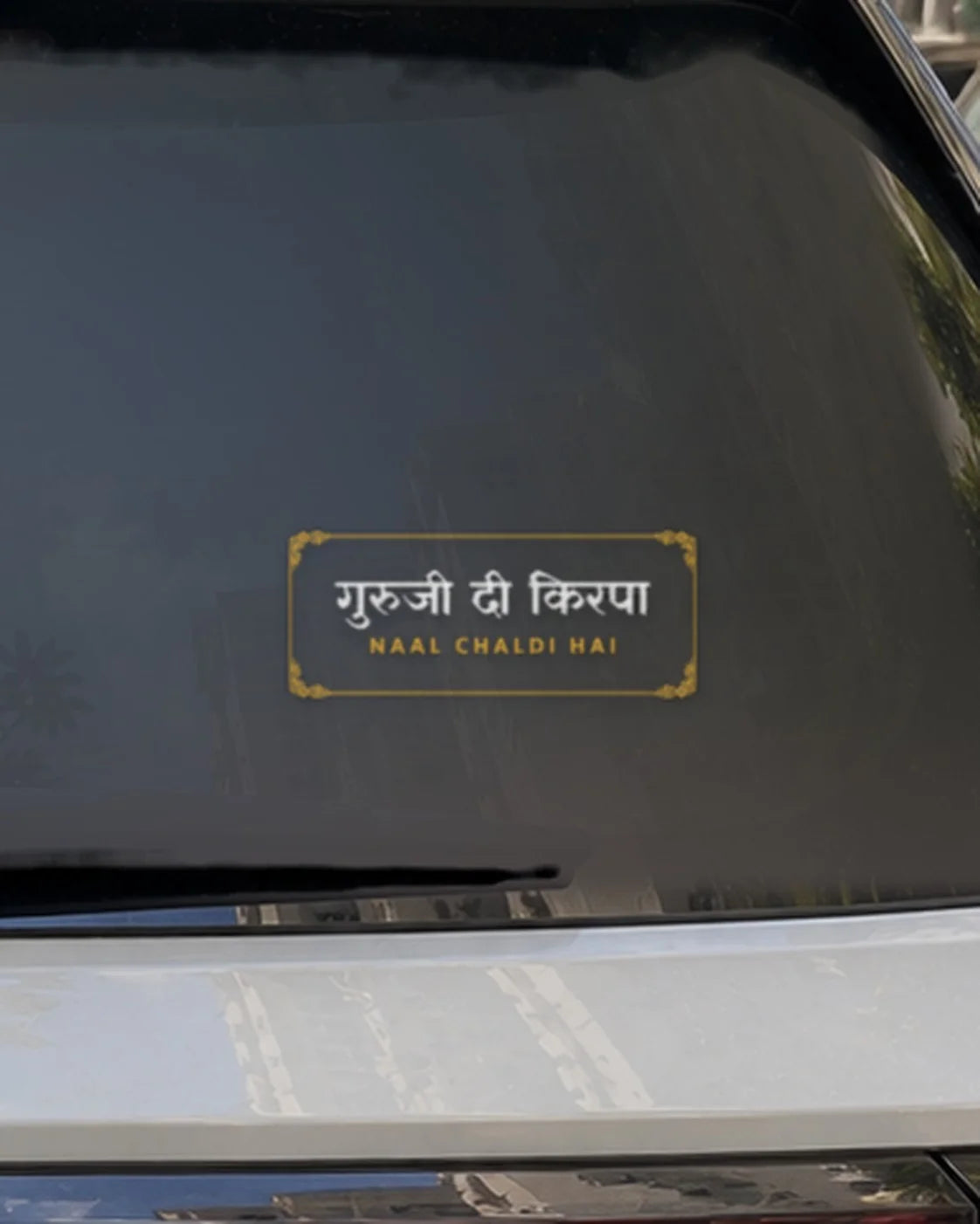 Guruji car patch on a car rear glass