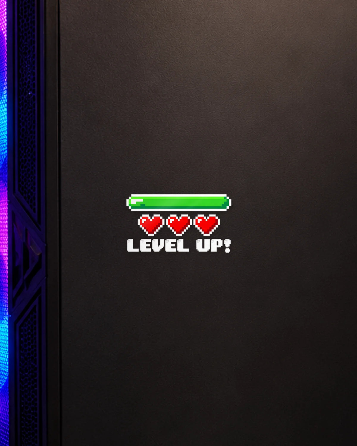 Level Up gamer patch in white ink on a gaming PC cabinet