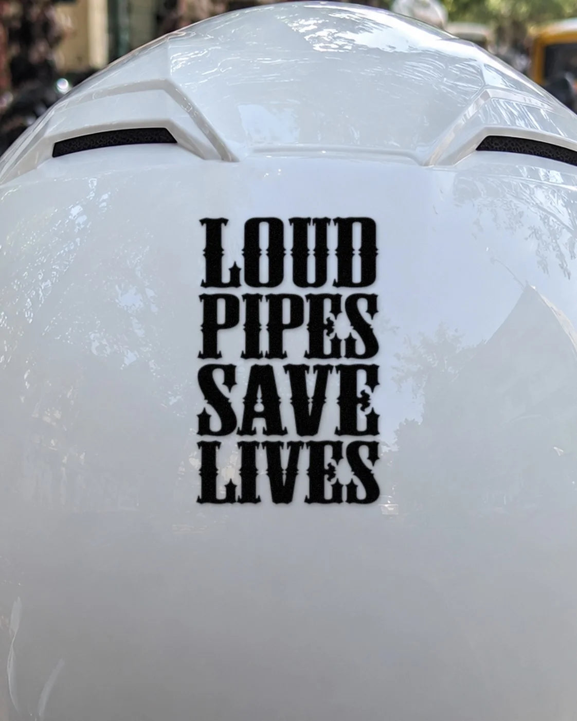 Loud Pipes Save Lives bike patch in black ink on a helmet