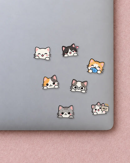 Peeking Cats mini patches on a laptop