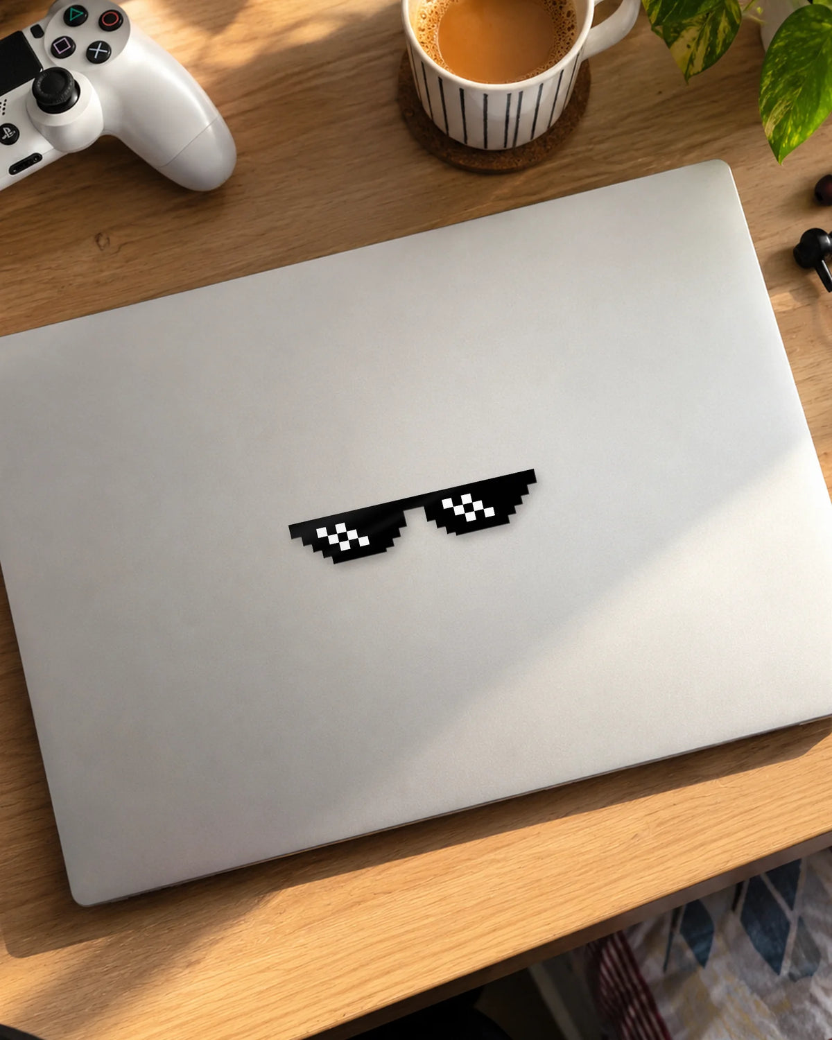 Pixel Shades gamer patch in black ink on a laptop