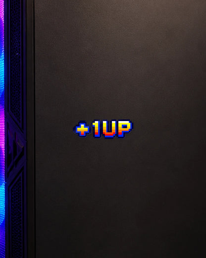 +1 UP gamer patch on a gaming PC cabinet