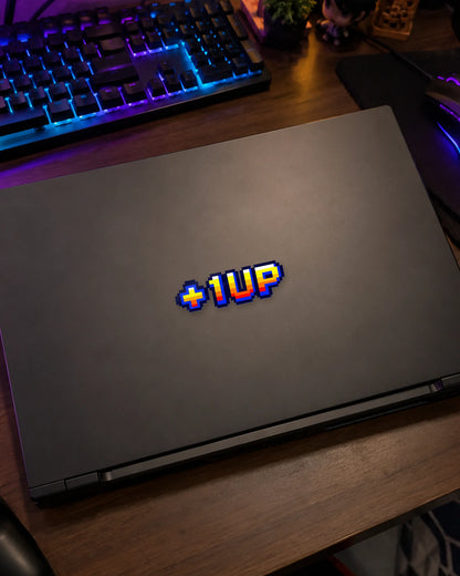 +1 UP gamer patch on a gaming laptop