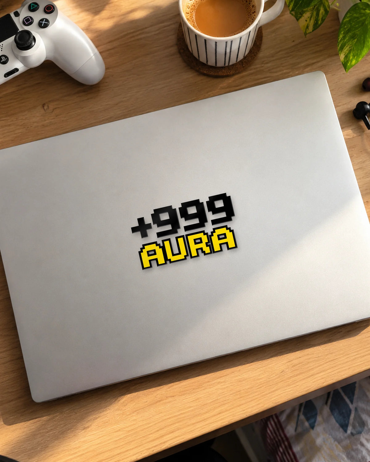 +999 Aura gamer patch in black ink on a laptop