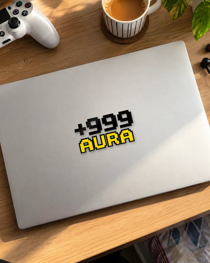 +999 Aura gamer patch in black ink on a laptop