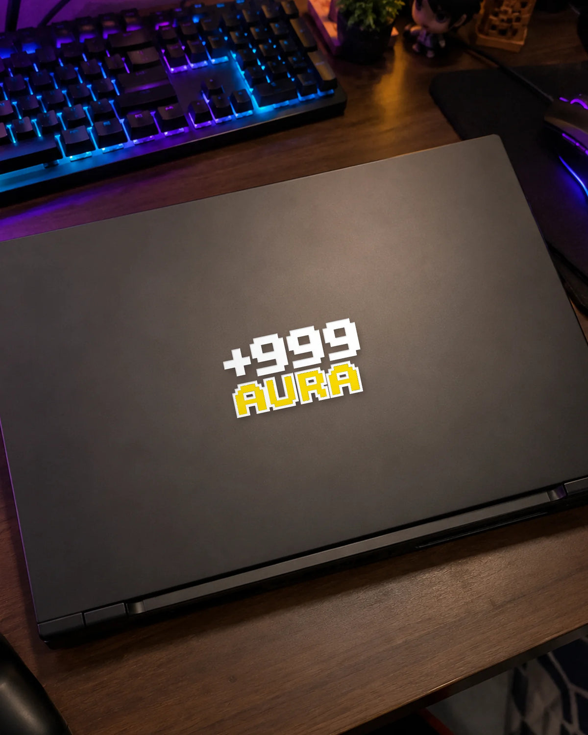 +999 Aura gamer patch in white ink on a gaming laptop