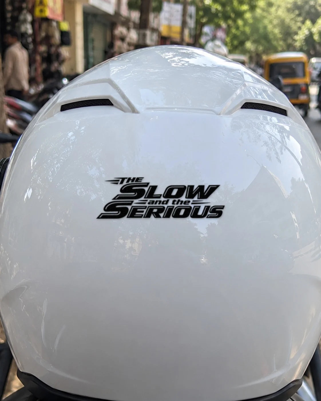 The Slow and the Serious bike patch in black ink on a helmet