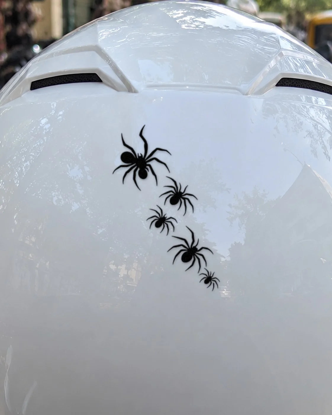 Spider Crawl bike patch in black ink on a helmet