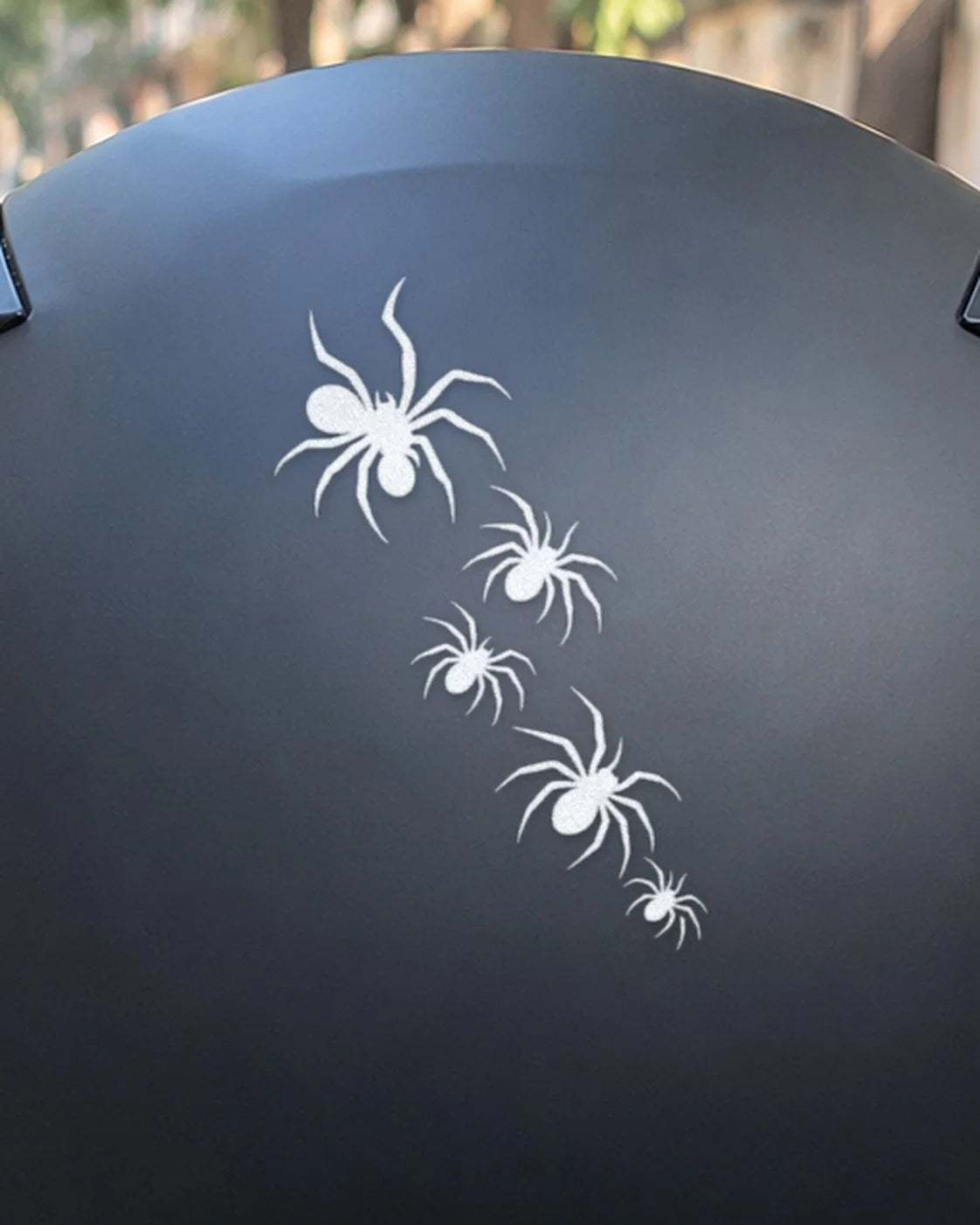 Spider Crawl bike patch in white ink on a helmet