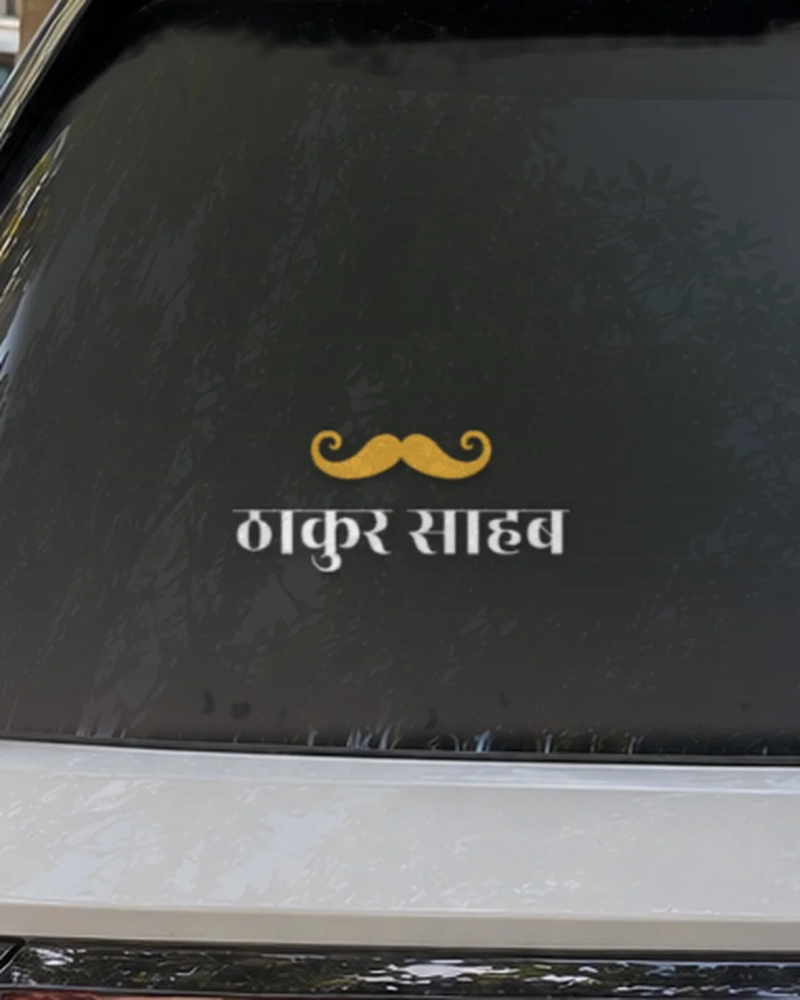 Thakur car patch on a car rear glass